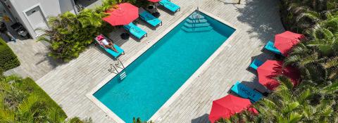 This image shows a serene pool area at a hotel or resort