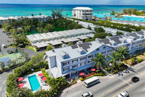 The image shows a luxury coastal resort complex with various amenities