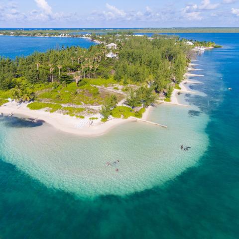This image features a beautiful aerial view of a tropical beach landscape