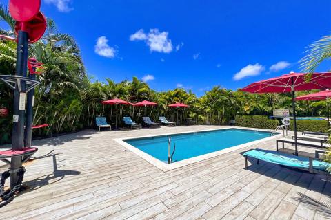 This image shows an inviting outdoor swimming pool area on a sunny day