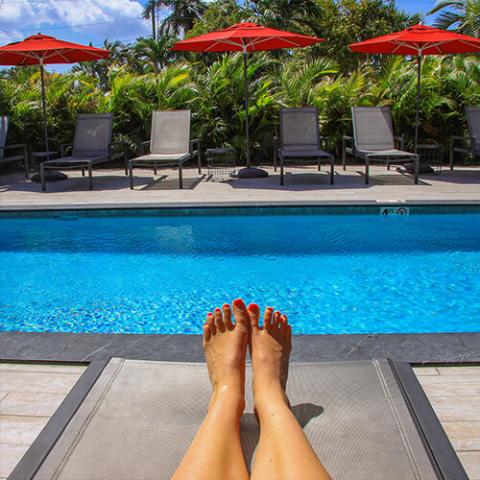 This image features a relaxing poolside scene