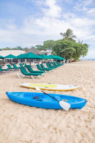 The image features a beach scene with a variety of leisure elements