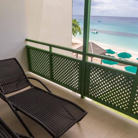 The image shows a beachfront balcony view