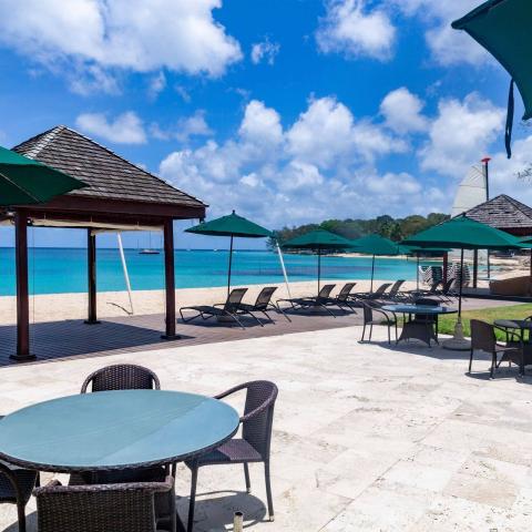 This image shows a beautiful beachside set-up, likely at a resort or similar vacation destination