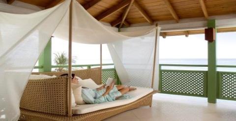 This image shows a serene and luxurious setting, likely at a beachfront property