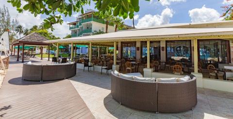 This image features a tropical beachfront dining area