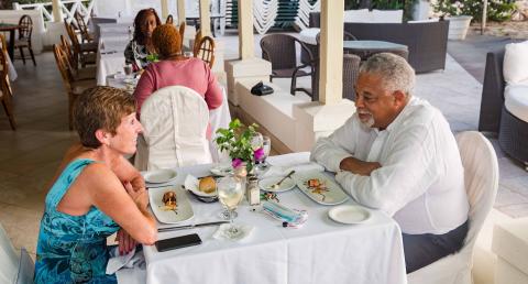 The image shows a dining scenario at an elegant outdoor restaurant
