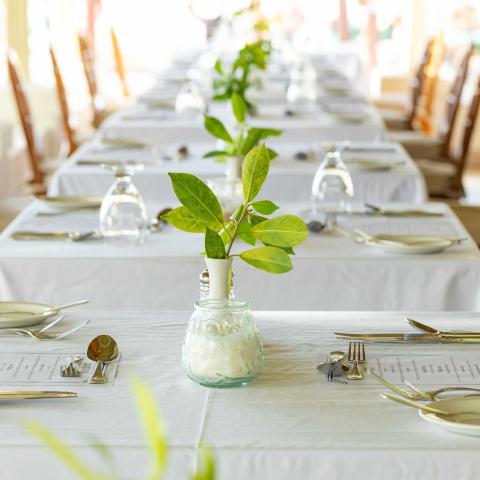 The image shows a decorated dining table set for an event