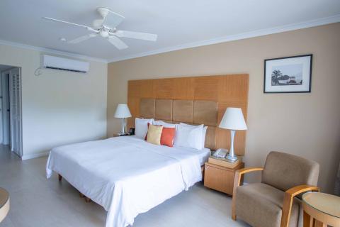 The image shows a neatly arranged bedroom, likely in a hotel or a similar accommodation