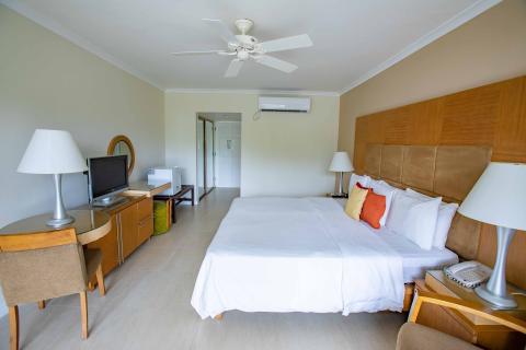 The image shows a spacious and neatly arranged hotel room