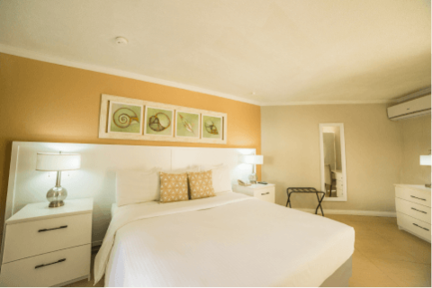 The image shows a well-lit bedroom with a contemporary design