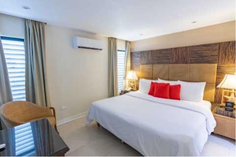 This image shows a modern bedroom with a bright and inviting decor
