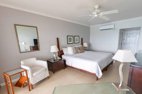 This image shows a well-furnished hotel room featuring a clean and spacious interior