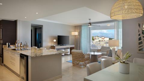 This image shows a modern, luxuriously decorated apartment interior with an open floor plan