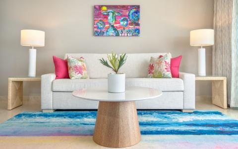 The image features a well-decorated living room with a modern aesthetic