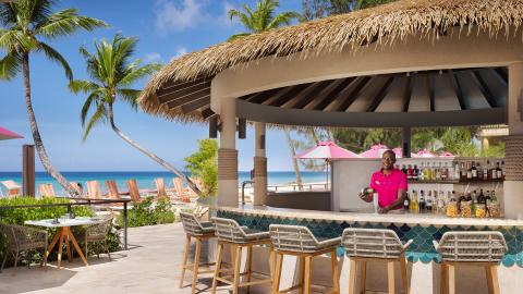 This image depicts a vibrant beachside bar setting