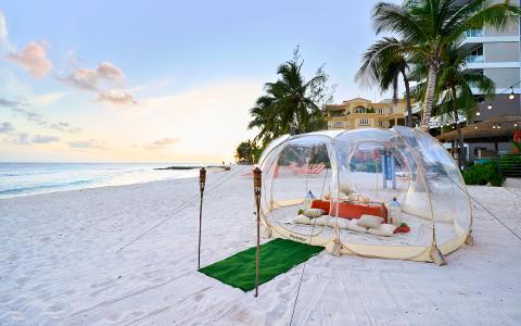 This image shows a picturesque beach setup during what appears to be evening or just before sunset