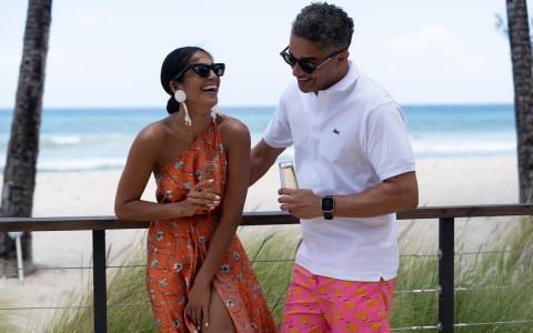 This image shows a man and a woman enjoying a sunny day at a beachfront location