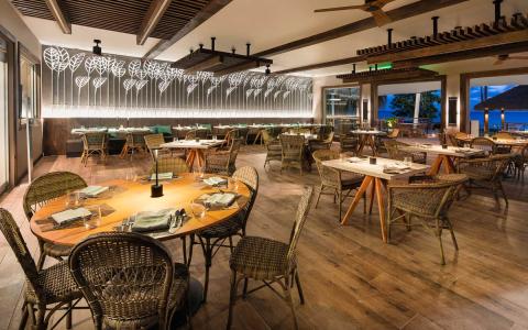 This image shows the interior of a stylish restaurant that features a blend of modern and rustic decor elements