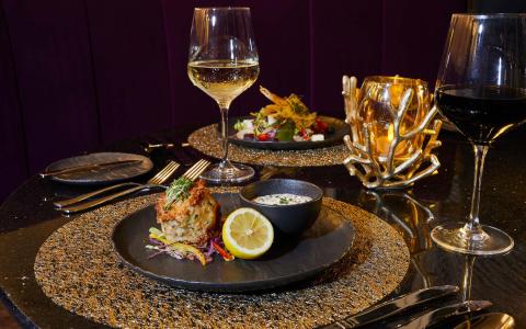 The image shows a beautifully arranged dining table that emphasizes elegance and gourmet dining