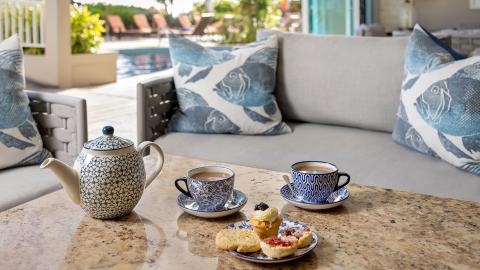 The image shows an outdoor setting with a serving of tea and snacks