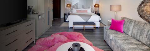The image shows a stylishly decorated hotel room or apartment suite