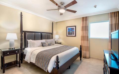 The image shows a well-appointed hotel or residential bedroom