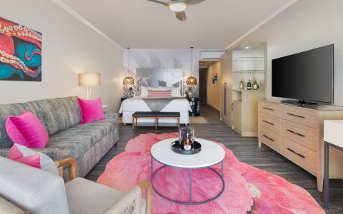 The image shows a modern and stylish hotel room or apartment suite