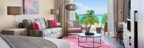 The image shows a stylishly furnished hotel room or suite