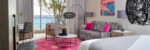 This image shows a stylish and well-decorated interior room that appears to be part of a resort or beach house