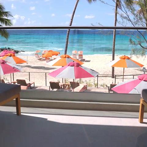 This image shows a scenic beachfront view, likely from a resort or hotel patio