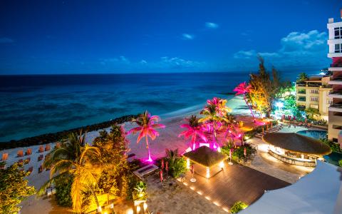 This image captures a beautiful nighttime scene of a beachfront area