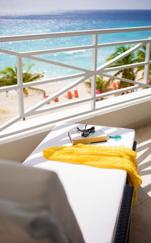 This image showcases a balcony overlooking a beautiful beach