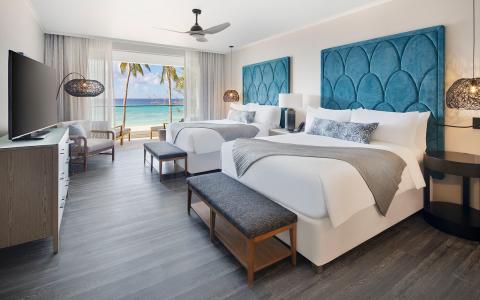 This image shows a luxurious hotel room with a modern and inviting design