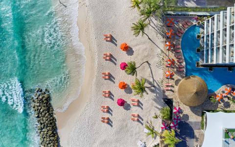 The image captures an aerial view of a scenic beachside setting