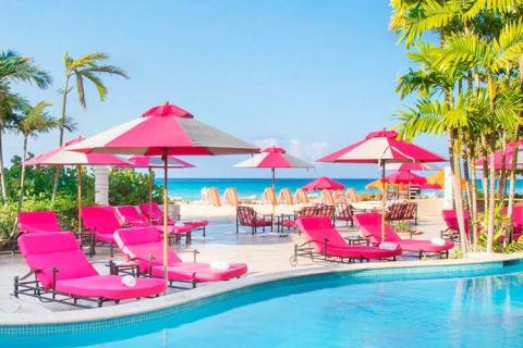 This image shows a luxurious poolside scene at a tropical resort