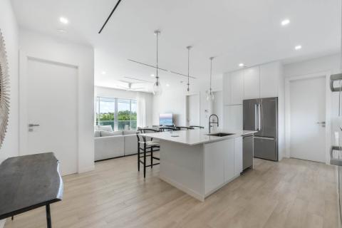 Open-plan kitchen and living area with balcony view