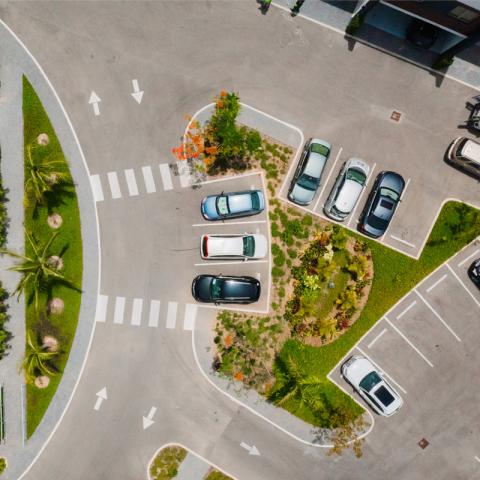 This is an aerial view of a parking lot with several cars parked