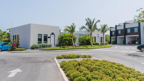 One Canal Point: Neatly landscaped residential area with modern buildings and tropical greenery
