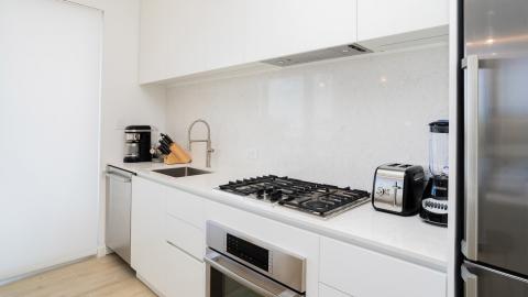 Modern Kitchen with White Cabinetry and Marble Backsplash