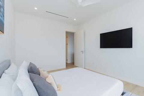 Modern bedroom with white cover and wooden floor