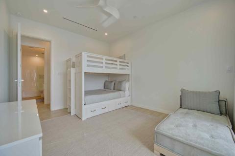  One Canal Point: Bright bedroom with white bunk bed, cushioned bench, and neutral decor  Title: One Canal Point: Bright bedroom with white bunk bed, cushioned bench, and neutral decor