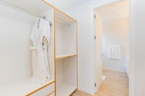 ONE Canal Point: Modern Walk-In Closet Connected to Bright Bathroom