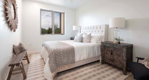 The image shows a modern, elegantly designed bedroom
