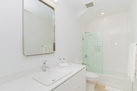 Modern bathroom with white color scheme and glass shower