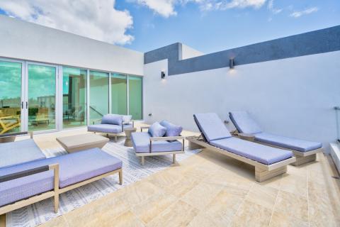 Modern outdoor terrace with lounge furniture and glass doors