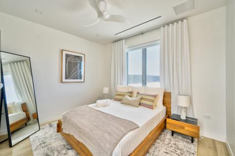 Modern bedroom with wooden bed frame and decorative pillows