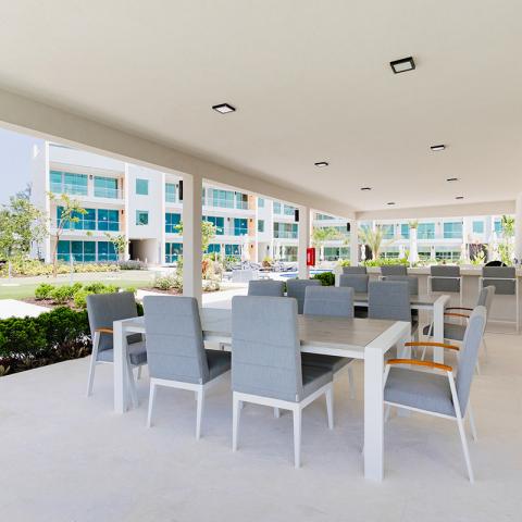 This image shows an outdoor seating area under a large, covered patio space
