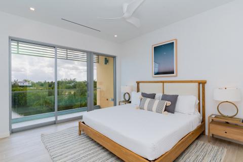 Modern bedroom with large window and queen-sized bed