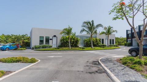 One Canal Point: Modern low-rise building with tropical landscaping and large windows